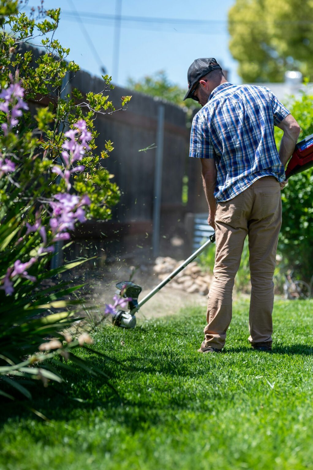 Crew member trimming the edge of a lawn