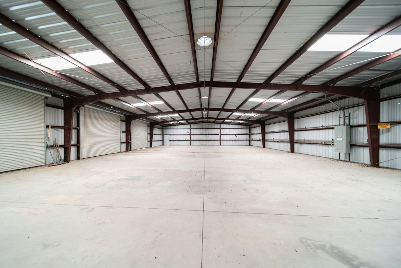 Empty steel-framed warehouse interior before racking installation