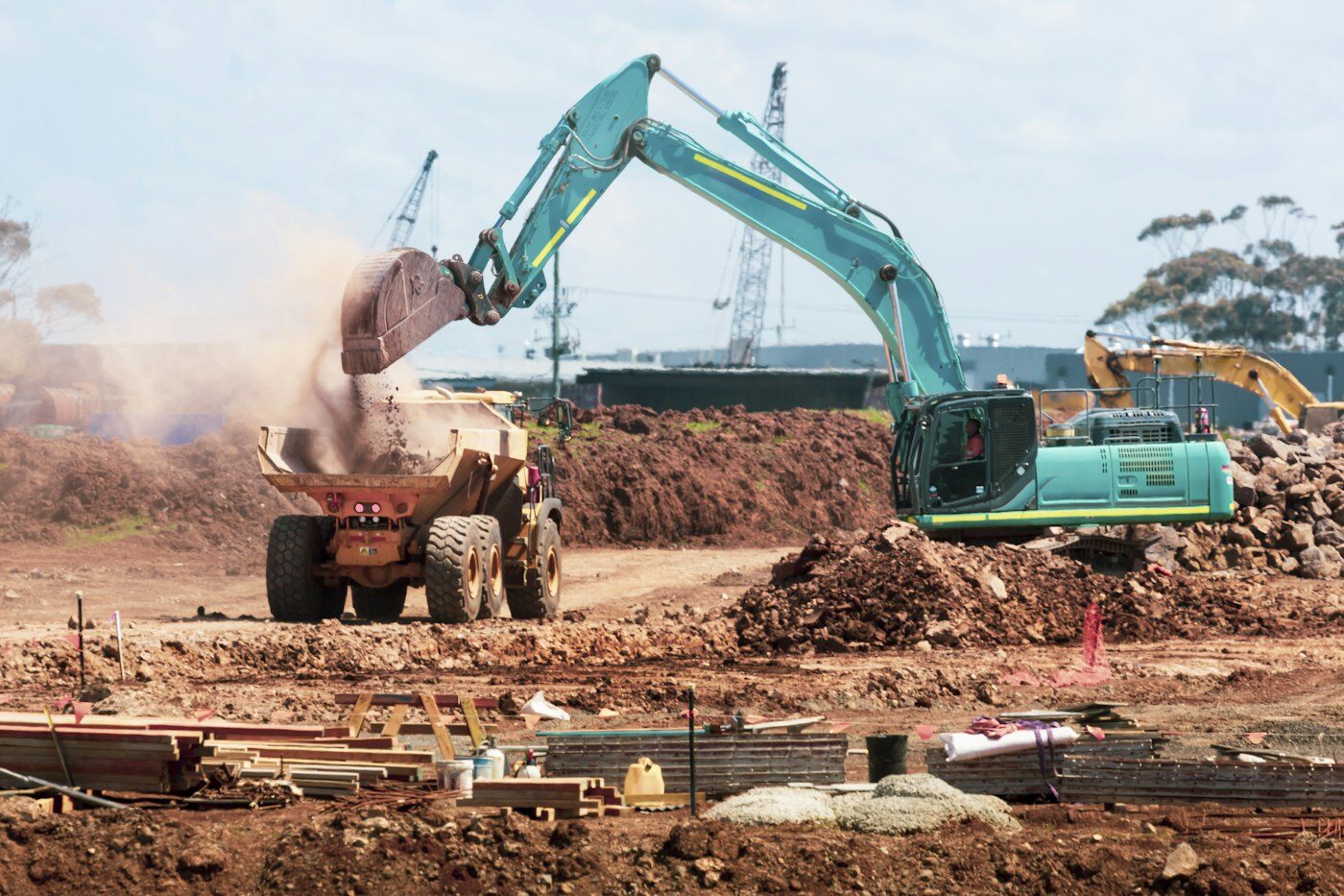Excavator loading a dump truck during bulk earthworks