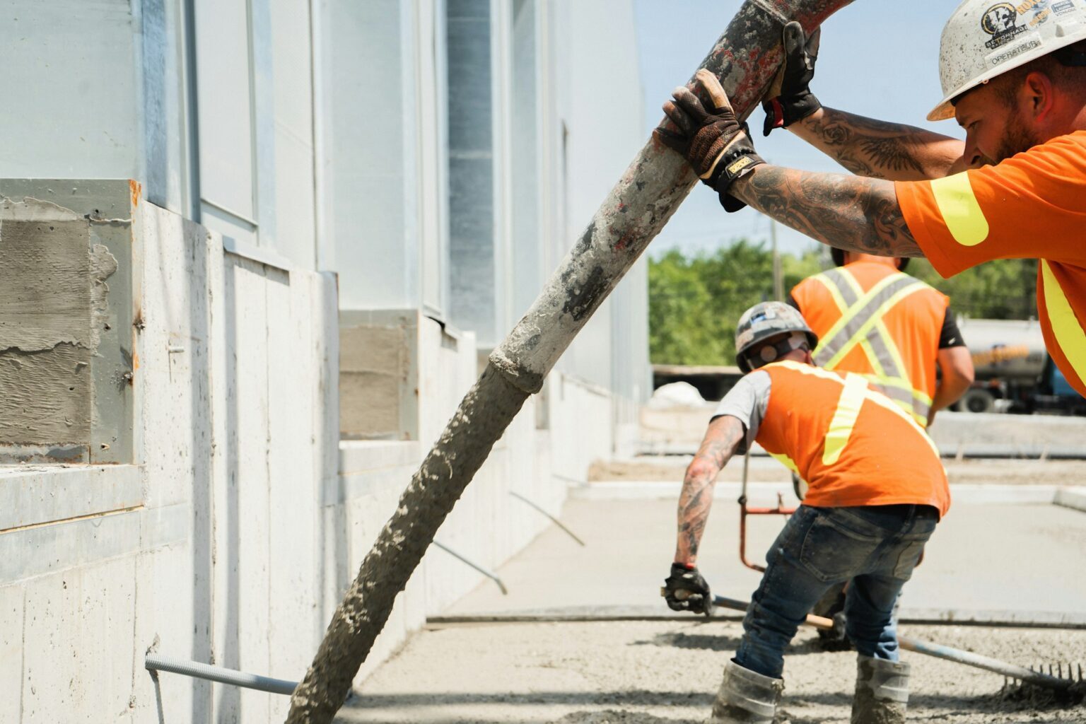 Construction team fixing reinforcement on a large concrete slab