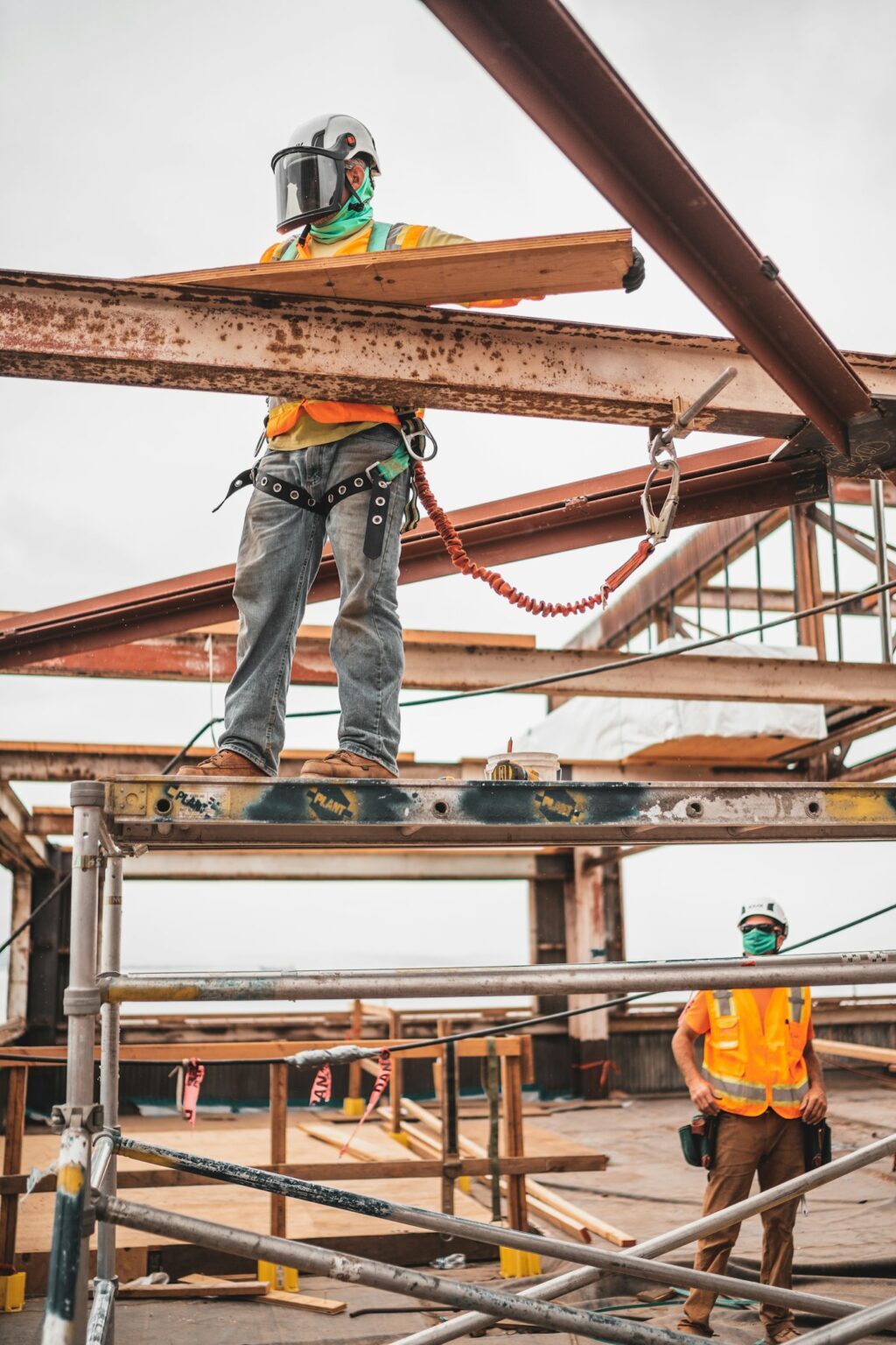 Worker on scaffolding fixing formwork